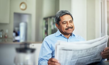 Senior Man Reading Newspaper Retire Invest Getty