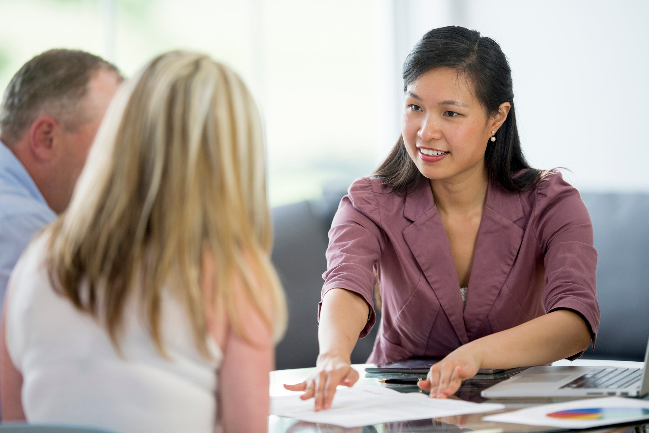 Two people speaking with a financial professional about retirement planning.