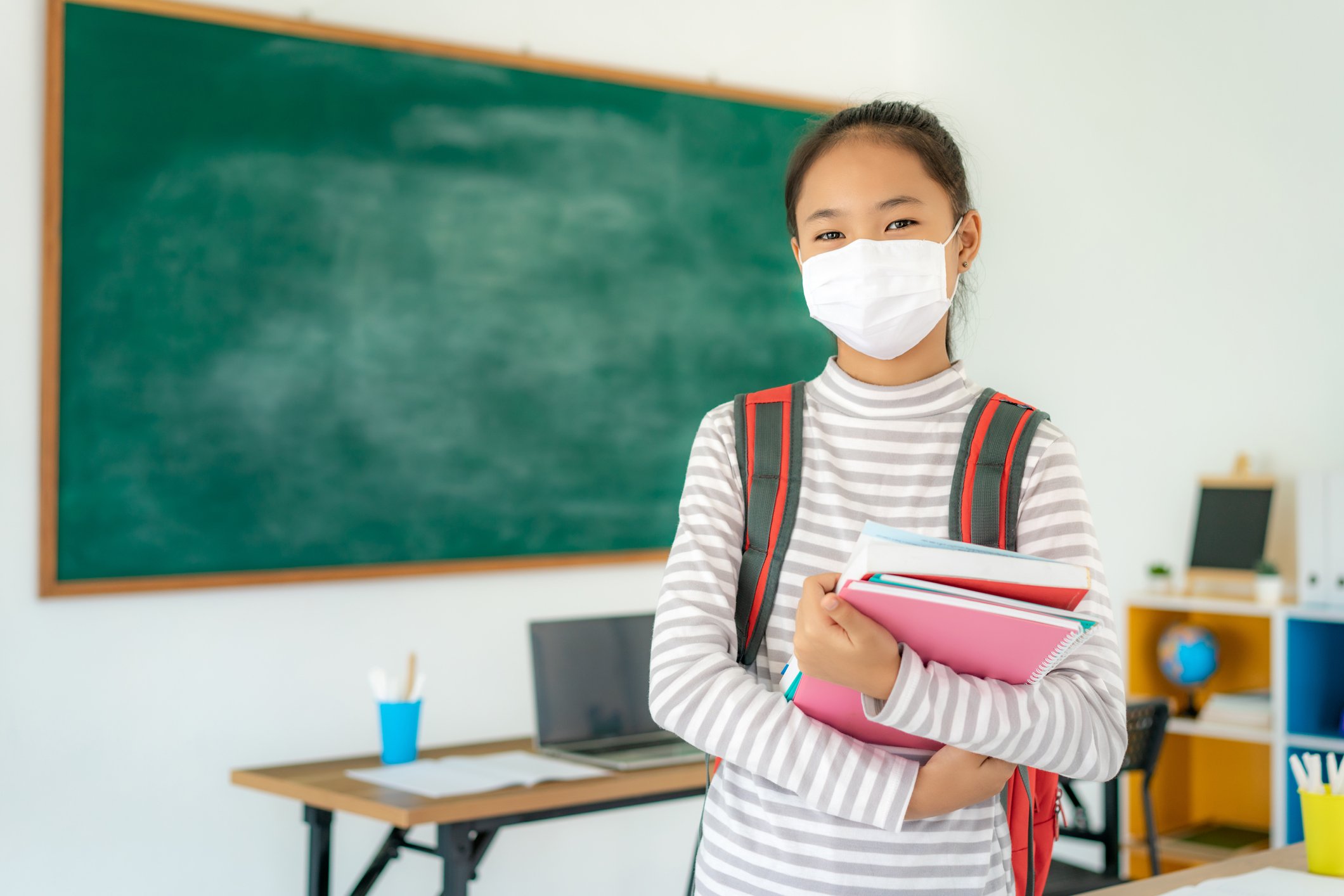 Masked student in a classroom