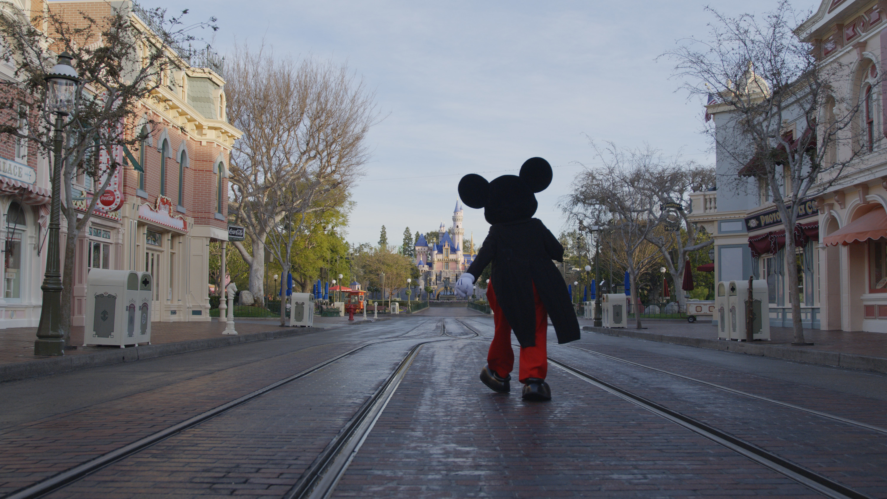 Mickey Mouse walks down Main Street USA.