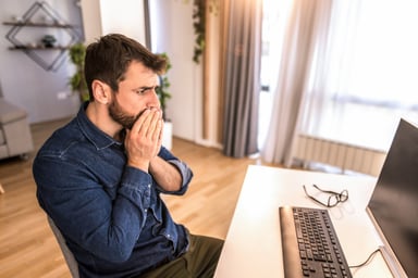 Shocked man looking at computer screen