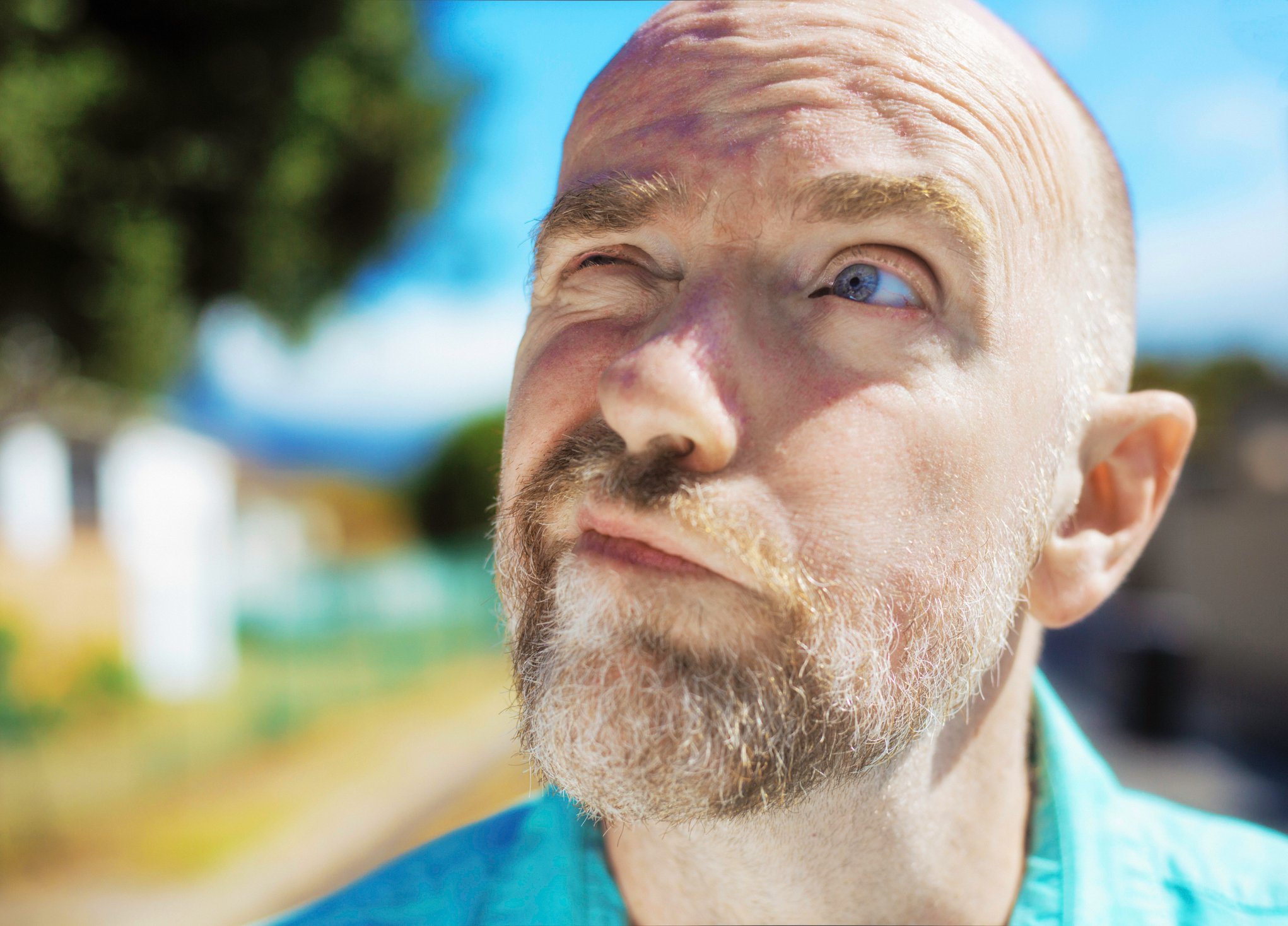 A person looks at the sky while pondering a decision.