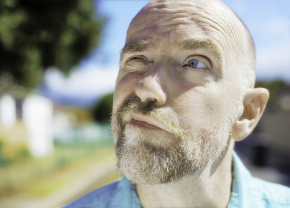 A person looks at the sky while pondering a decision.