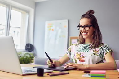 Lady Graphic Designer Smiling at Laptop