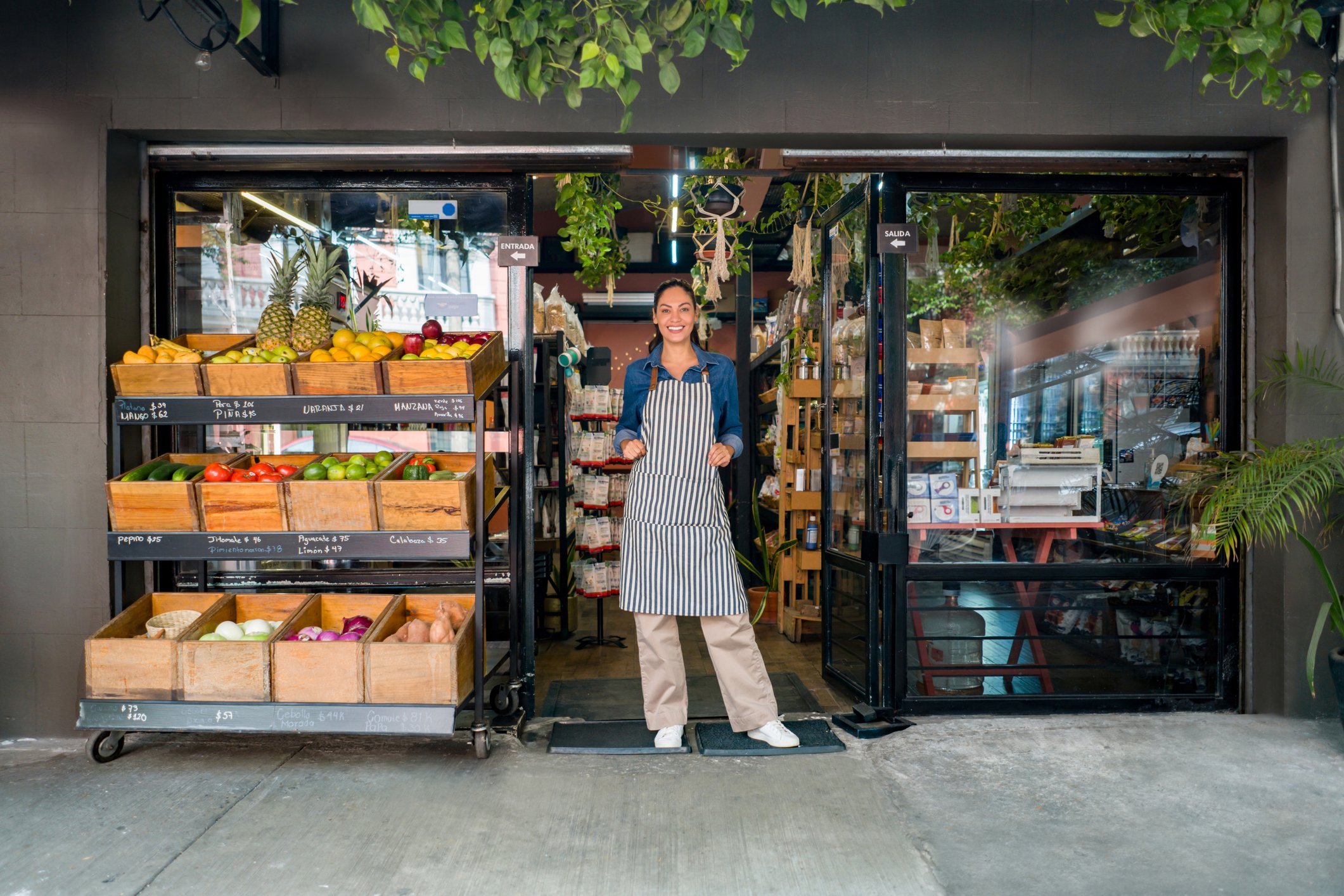 Person standing in doorway of food market.