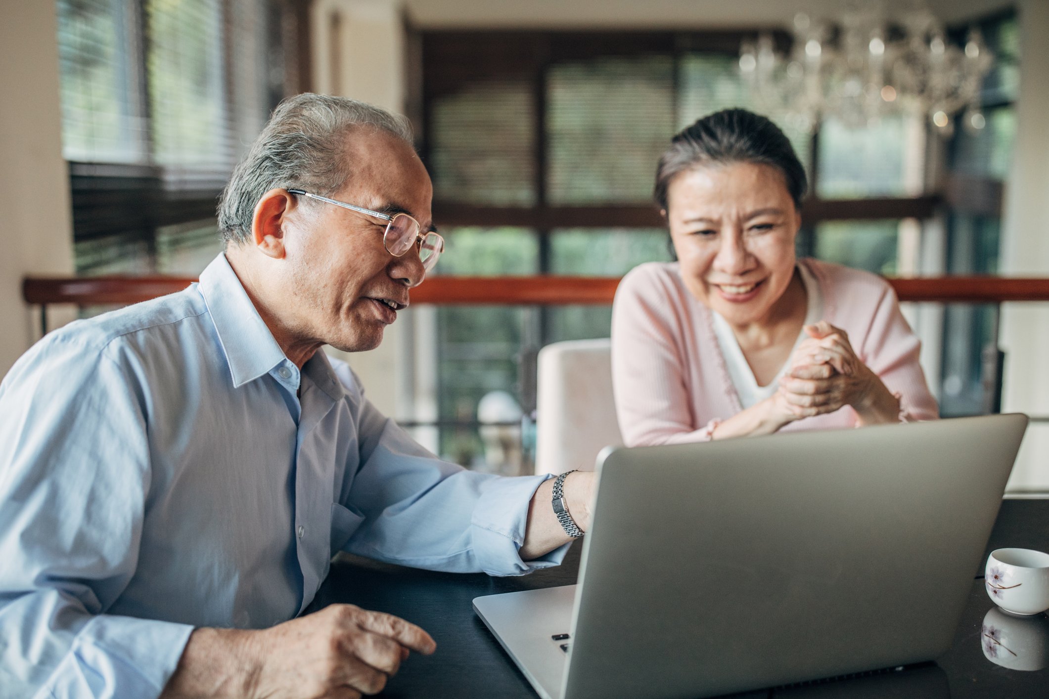 Older Asian couple with laptop