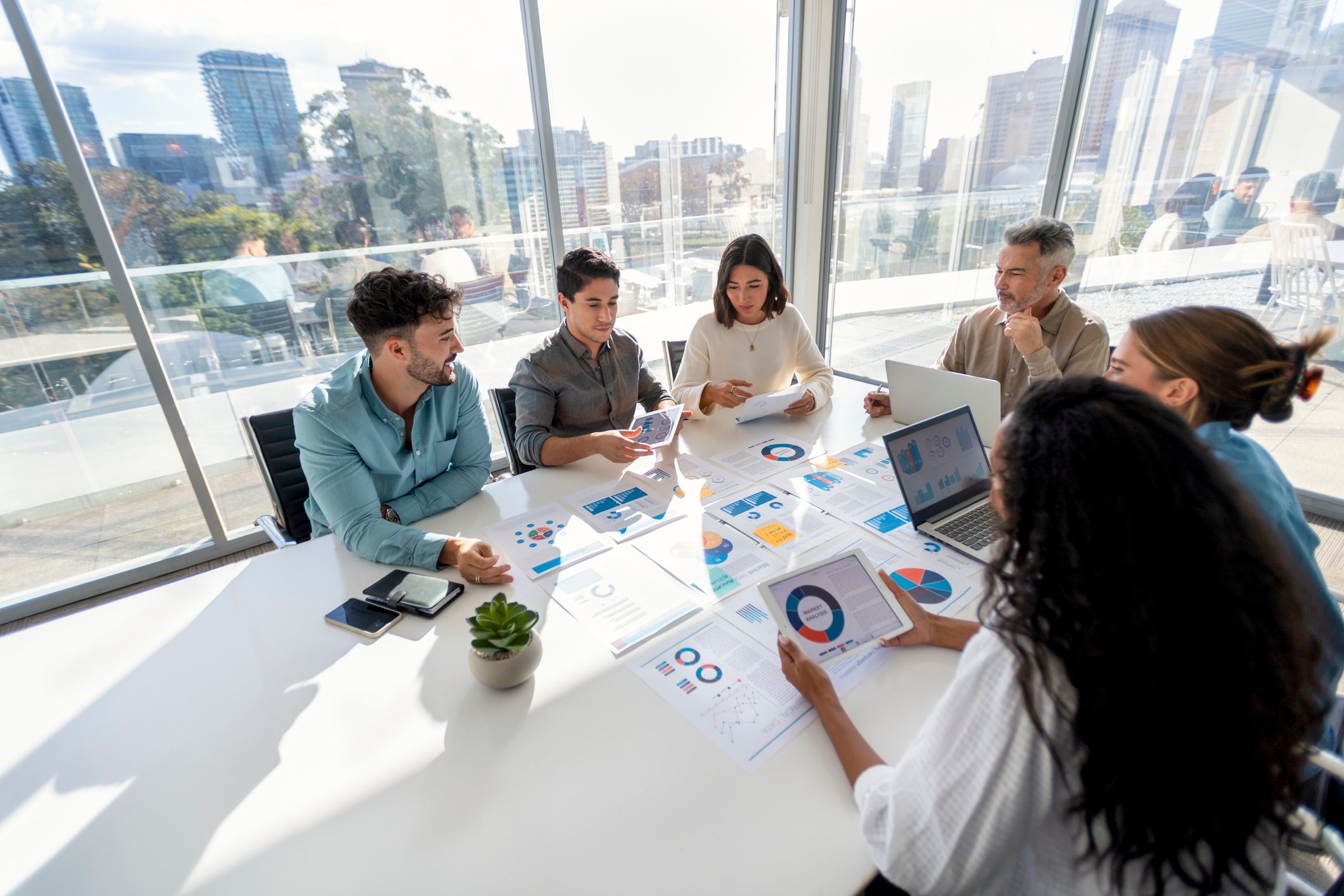 A team working in an office and sharing data insights.