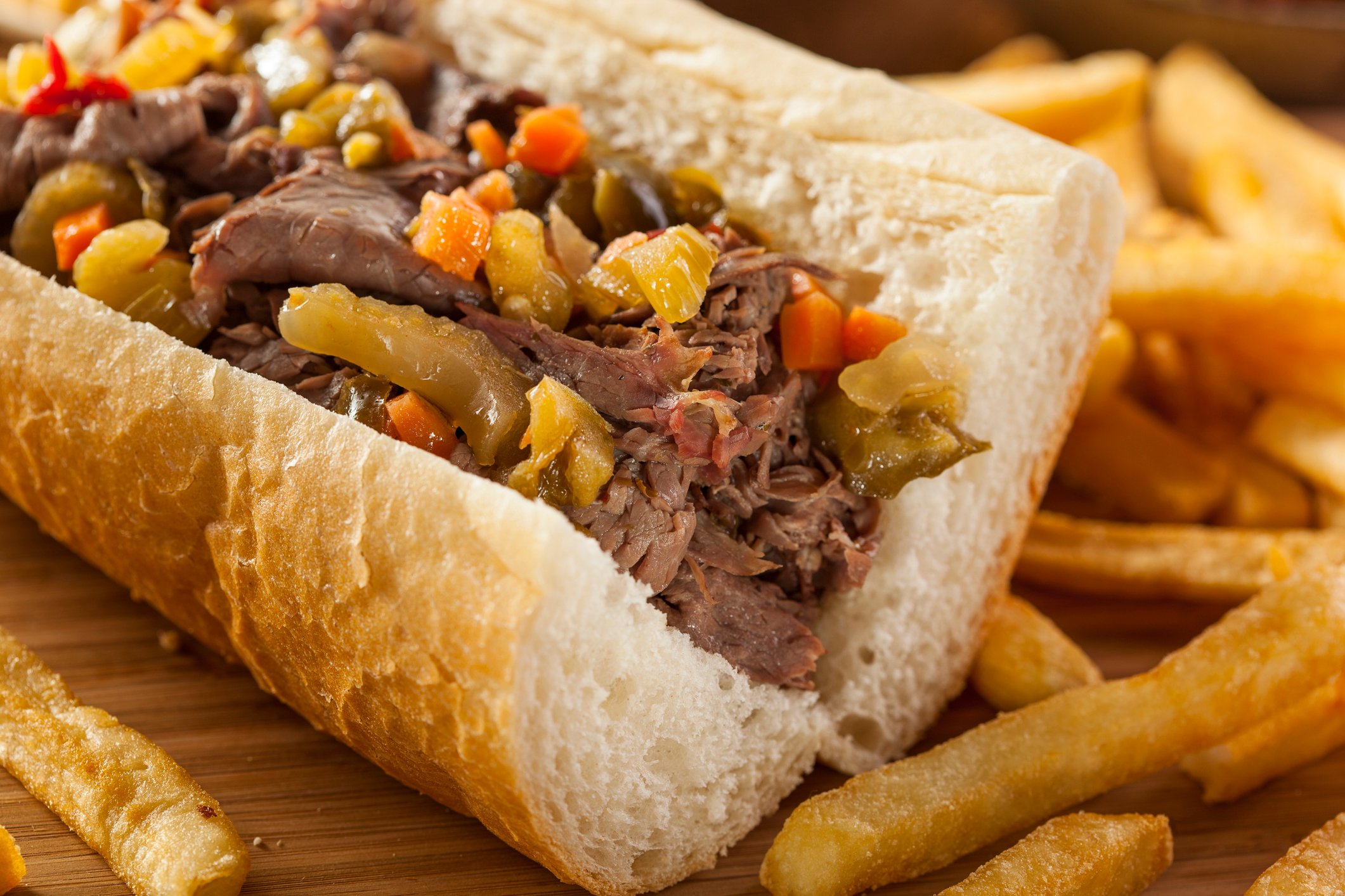 Italian beef sandwich with a side of fries.