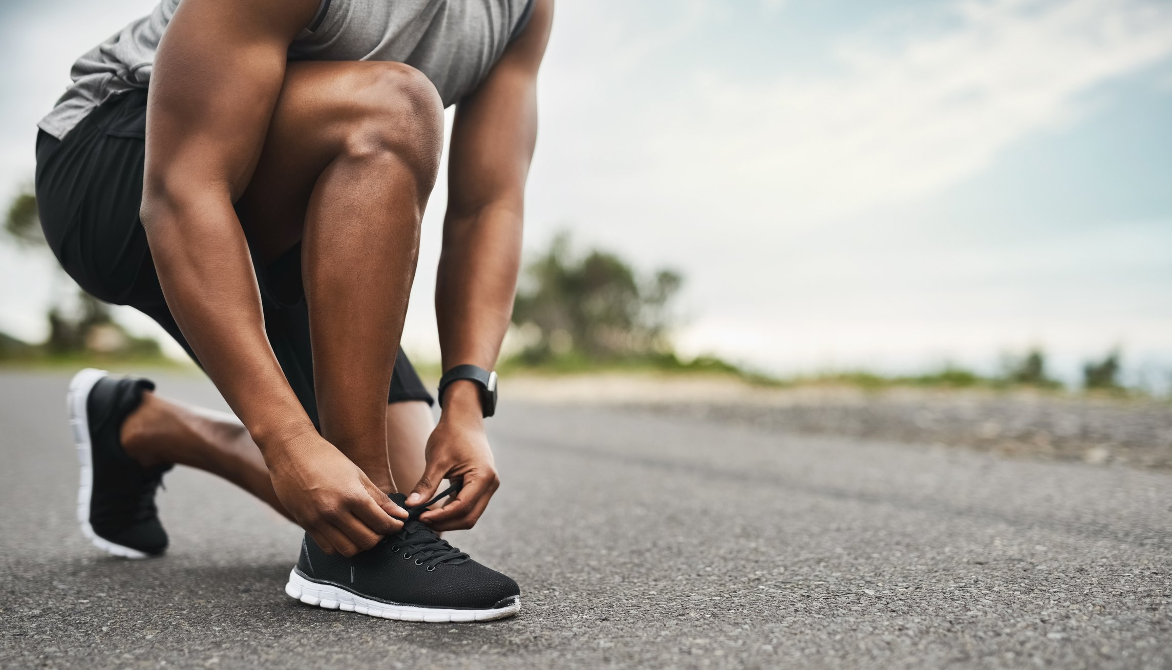 runner lacing up shoes