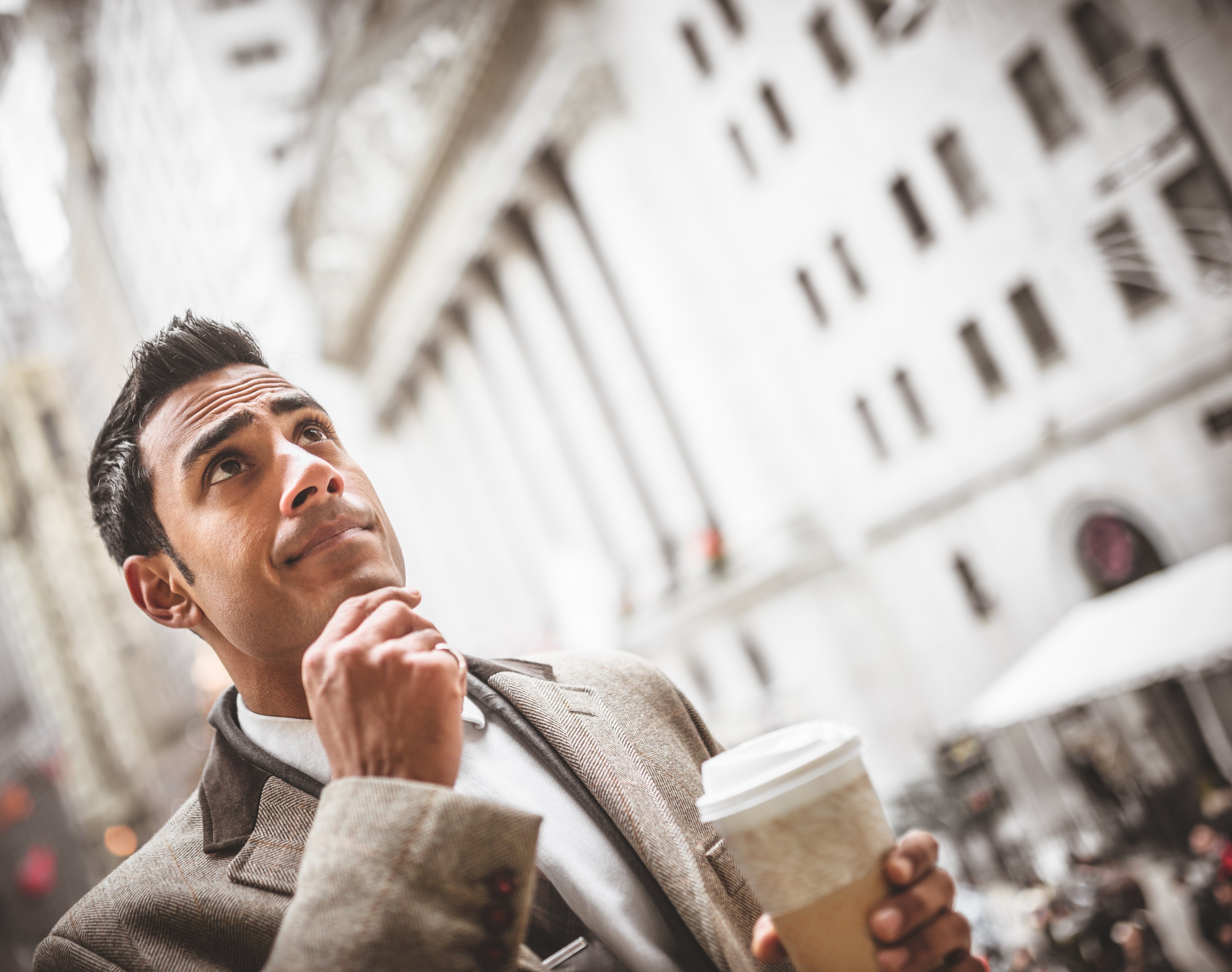 pensive wall street man coffee walk