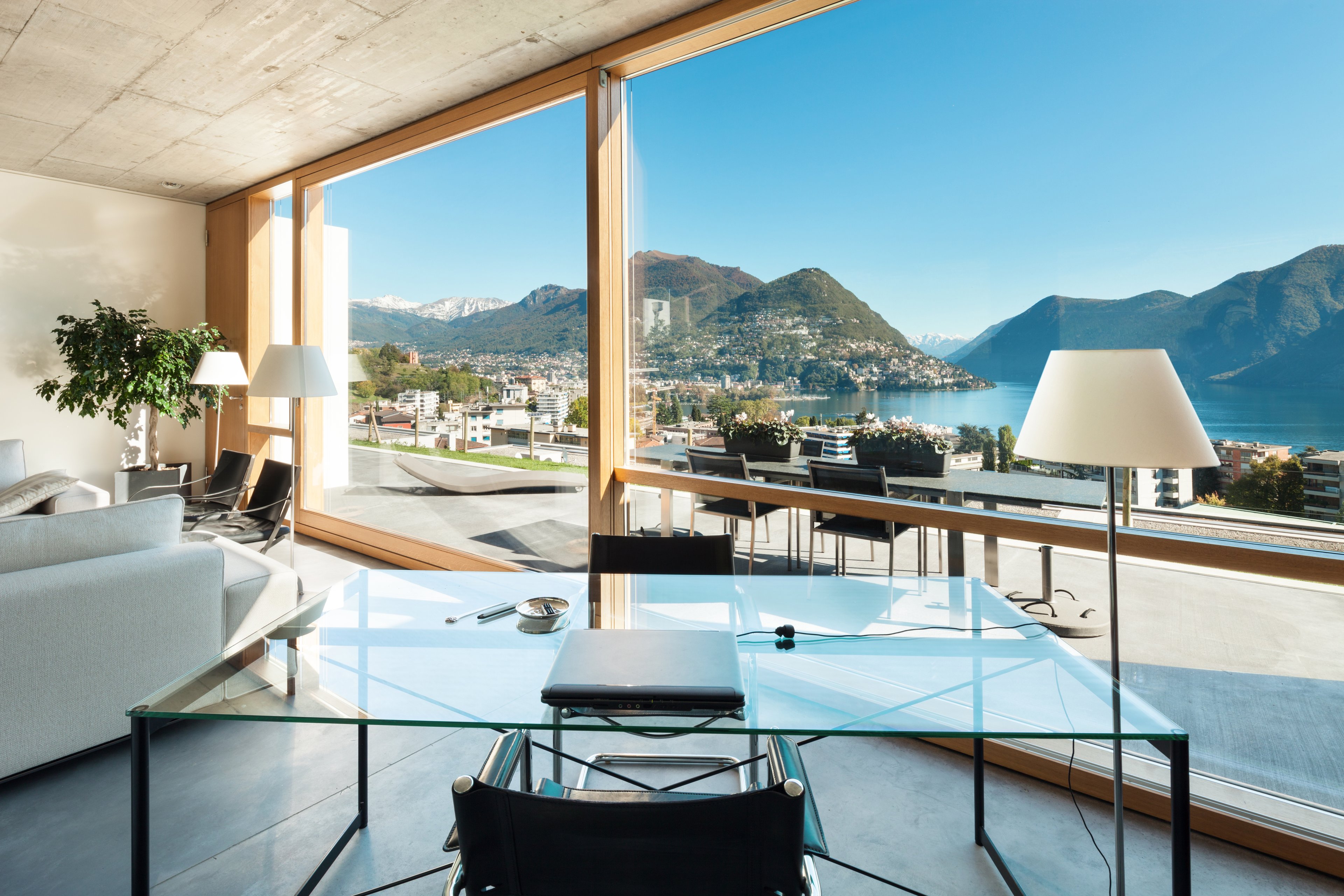 Bright room overlooking a bay and mountains.