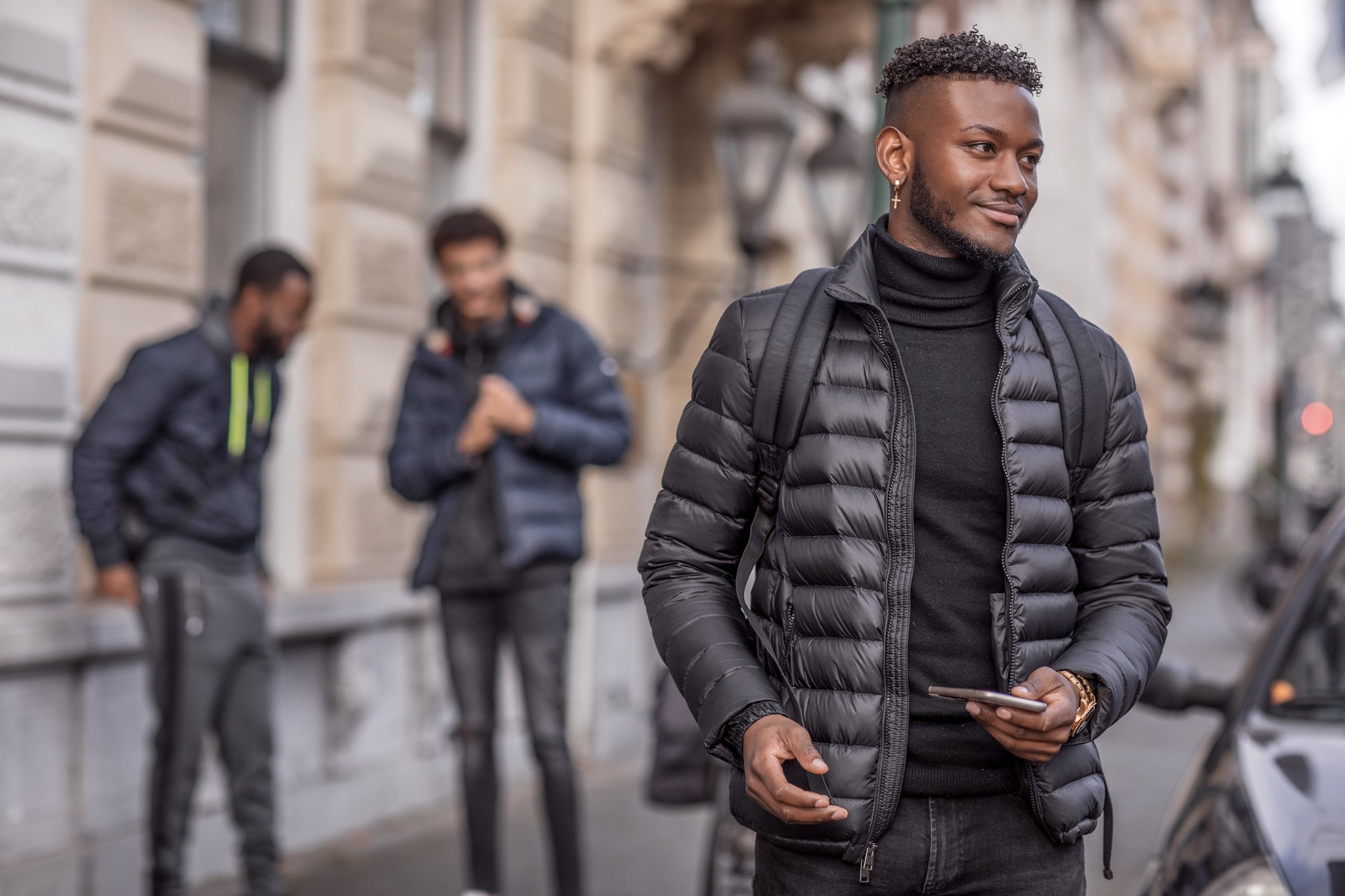 A young man wearing a winter puffer jacket in the city