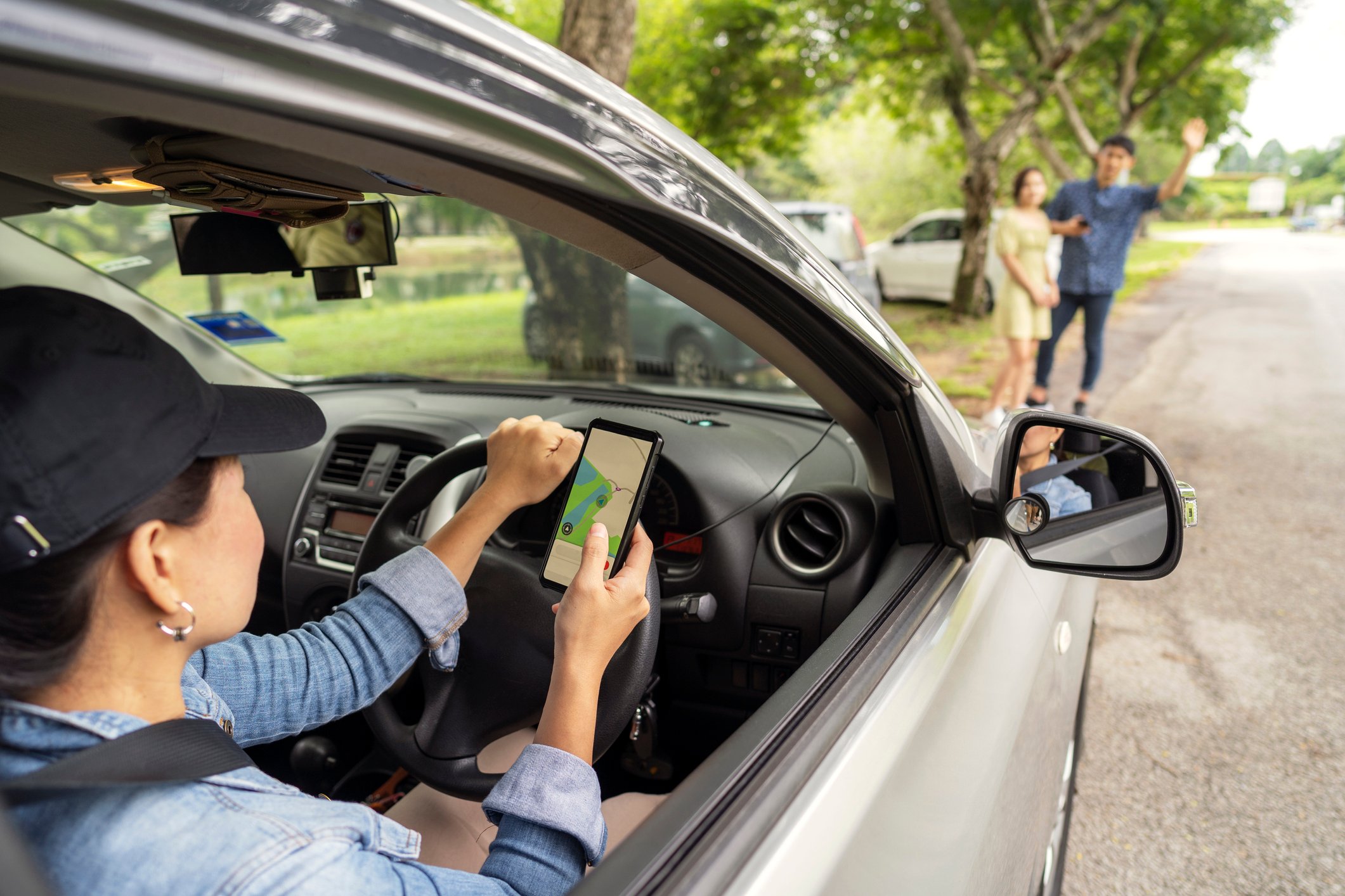 Rideshare taxi approaching customer at roadside