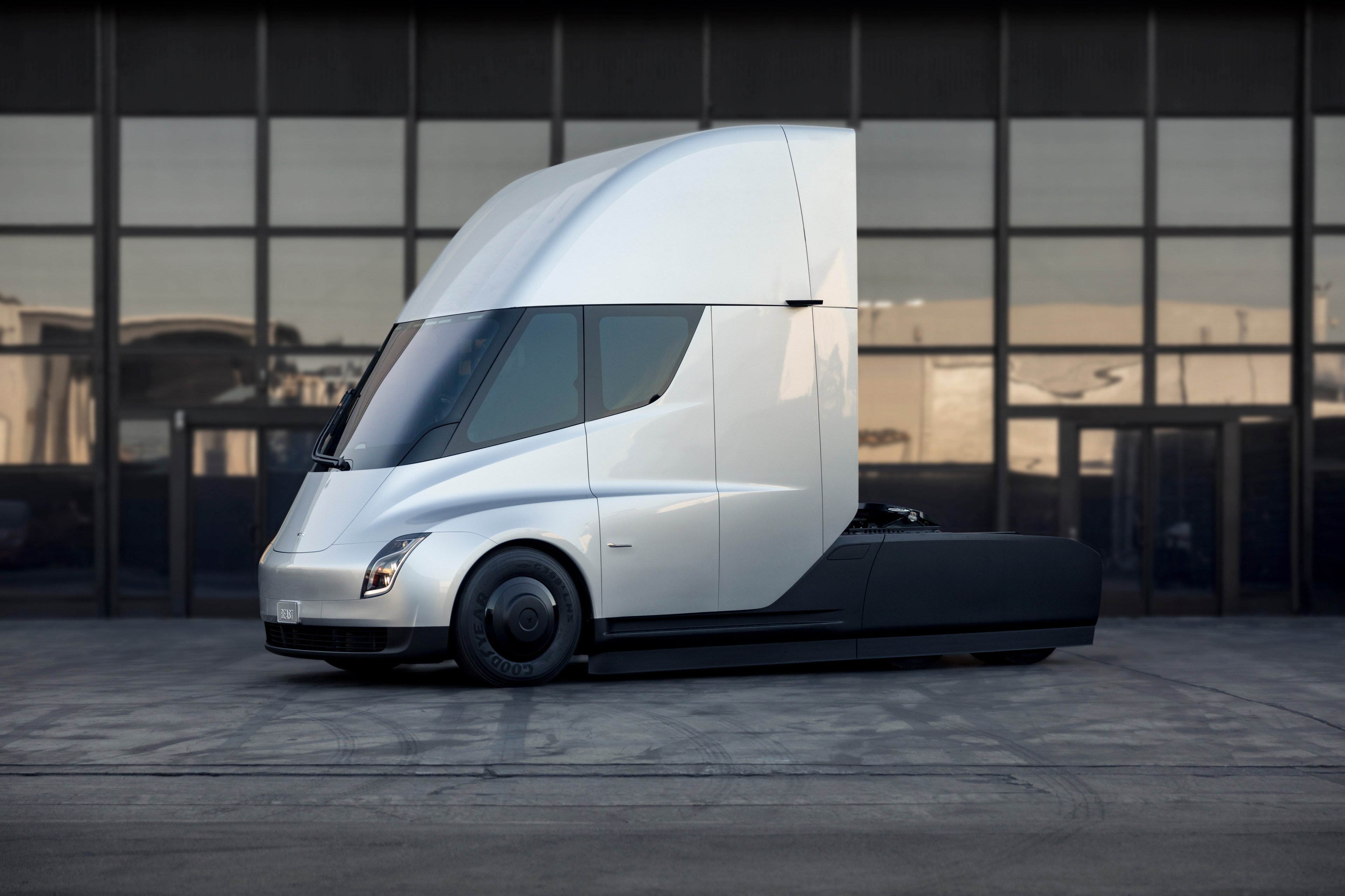 Tesla Semi truck parked in front of windows. 