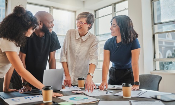 Four people in a conference room.