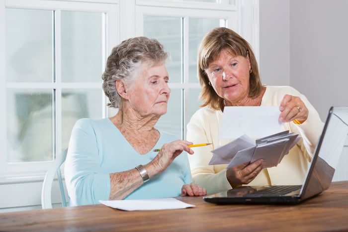 Two people discussing financial documents.