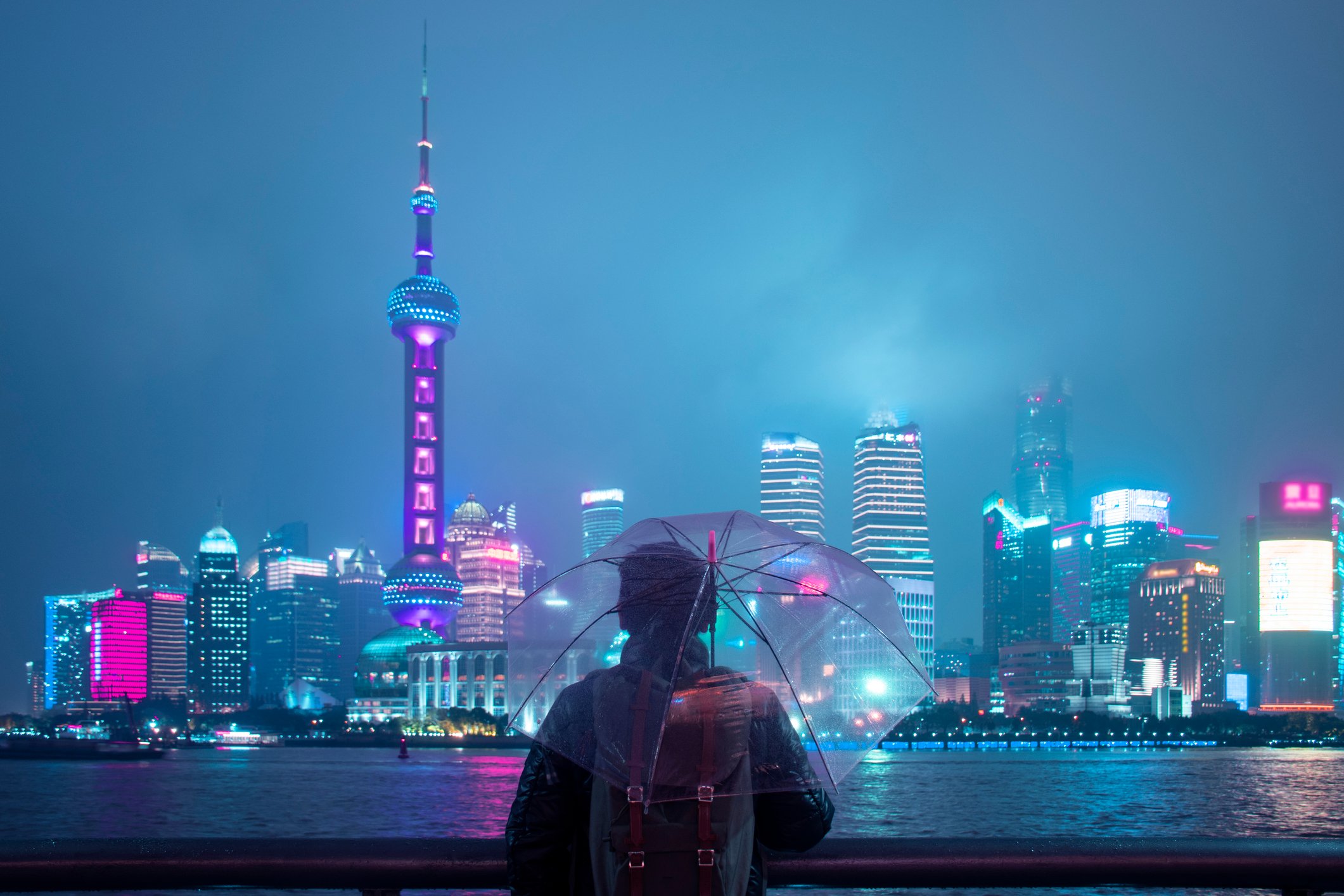 A person holds an umbrella on a rainy day in Shanghai.