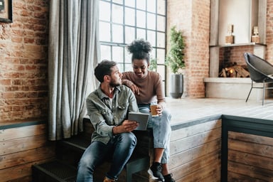 Couple in loft looking at tablet.
