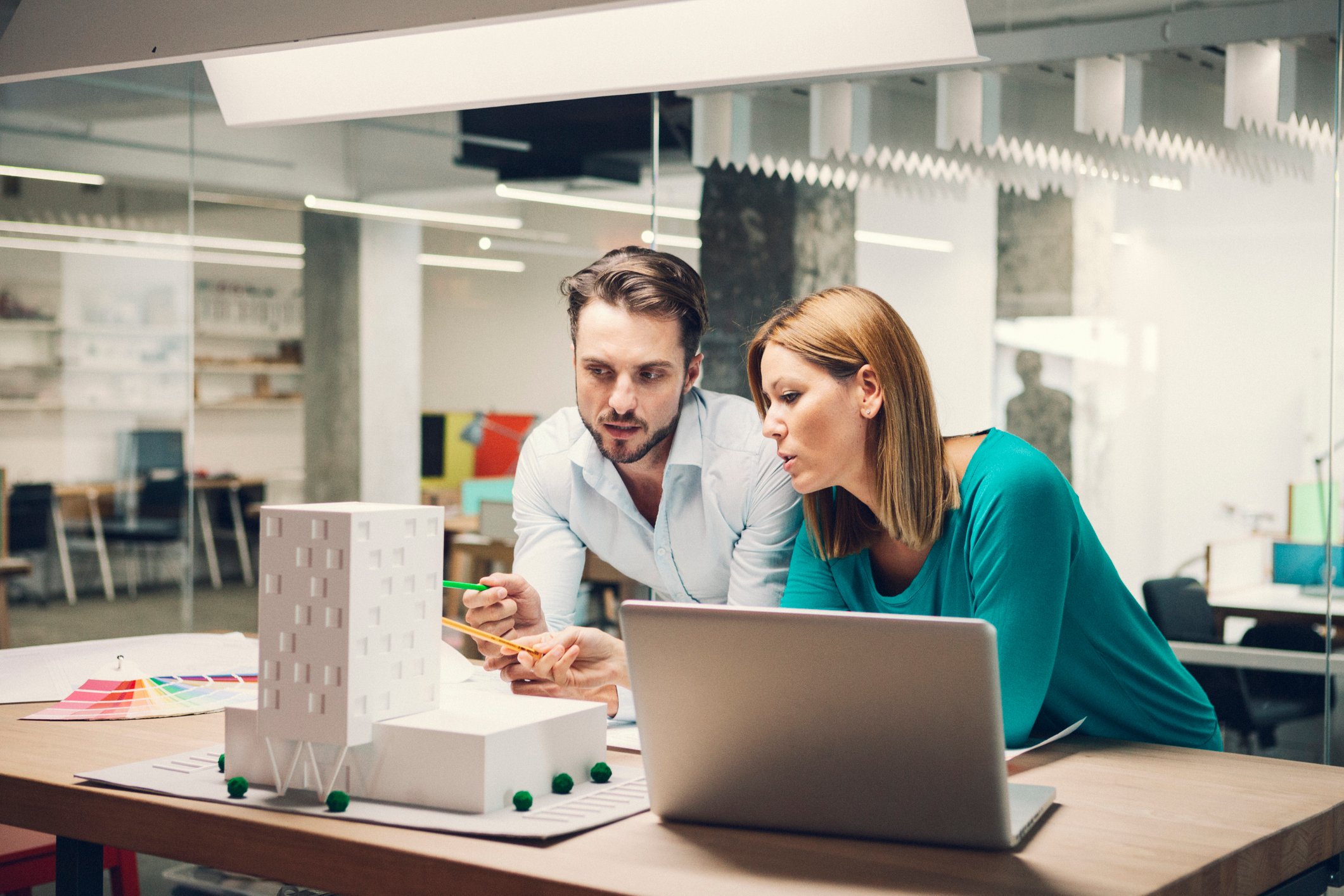 Two architects discuss a building design.