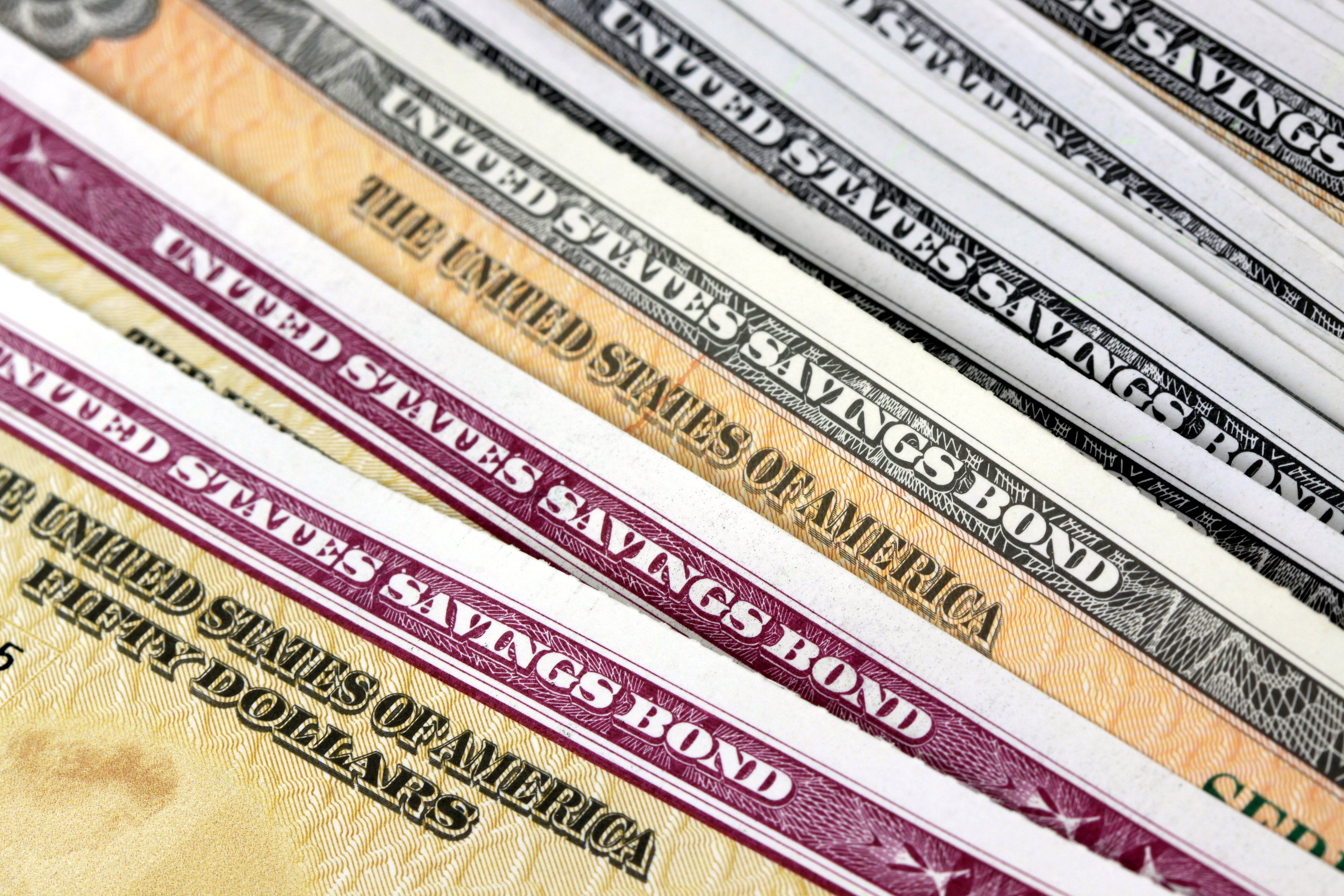 U.S. savings bonds in a loose stack.