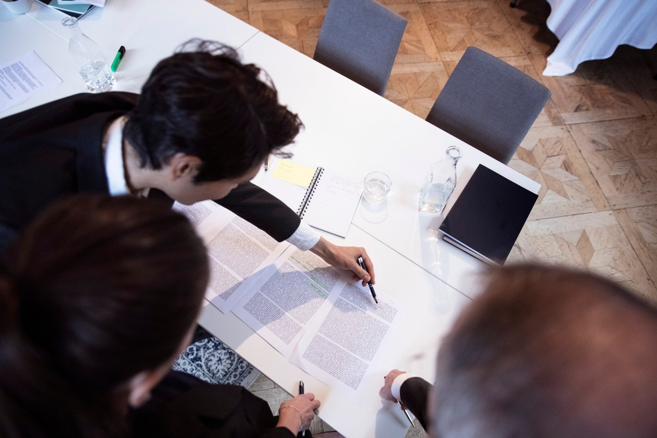 People looking at documents on table.