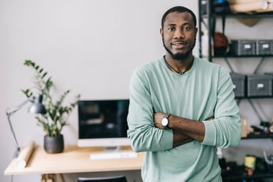 Cryptocurrency investor standing in front of desk