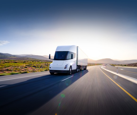 A Tesla Semi driving on a deserted highway.