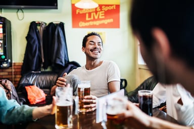 Group of friends drinking at a table.