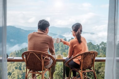 Couple enjoying coffee overlooking a mountain