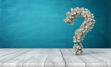 A question mark made of hundred-dollar bills.