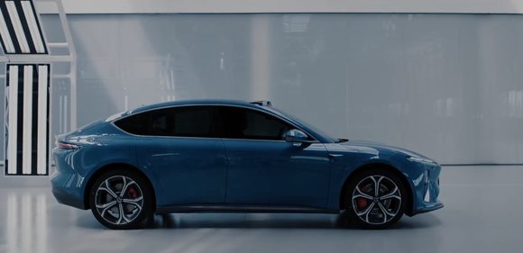 Blue Nio ET5 profile view coming off production line.