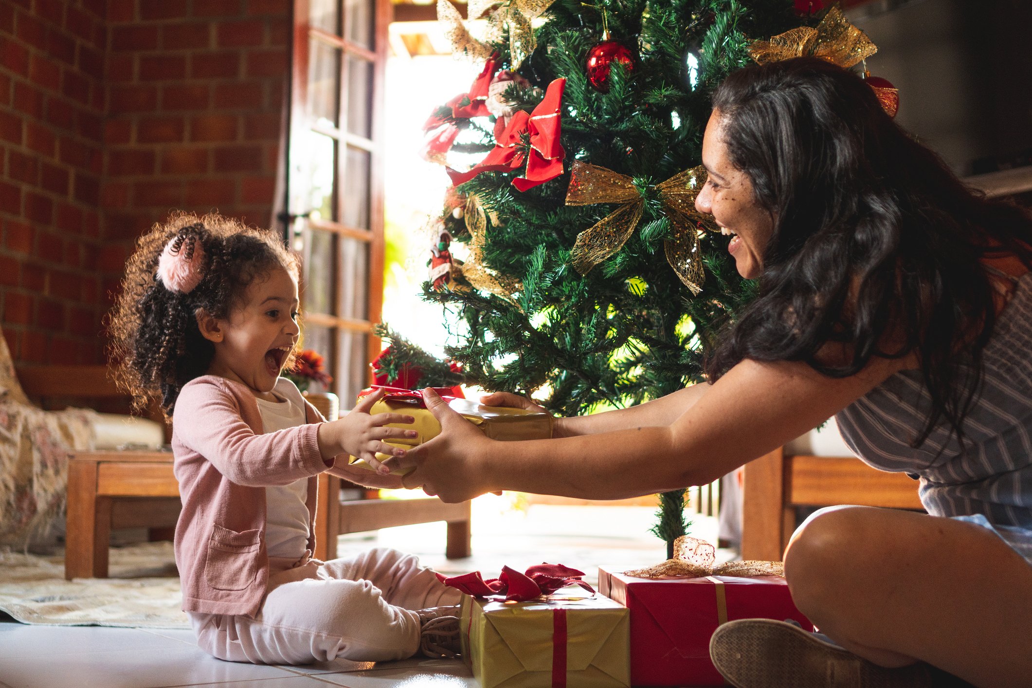 Person giving a gift to their child. 