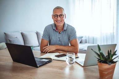 Man middle aged smiling laptop