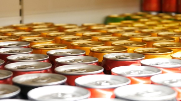 Close-up photo of the tops of various aluminum soft drink cans. 