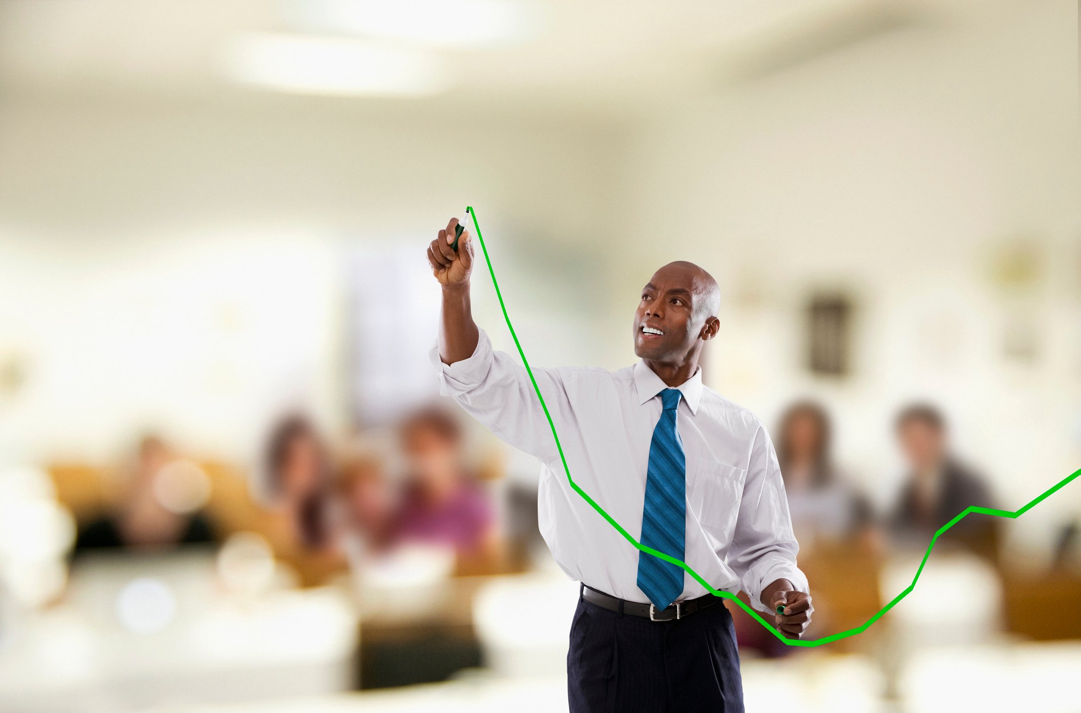 A person drawing a green arrow on a glass board.