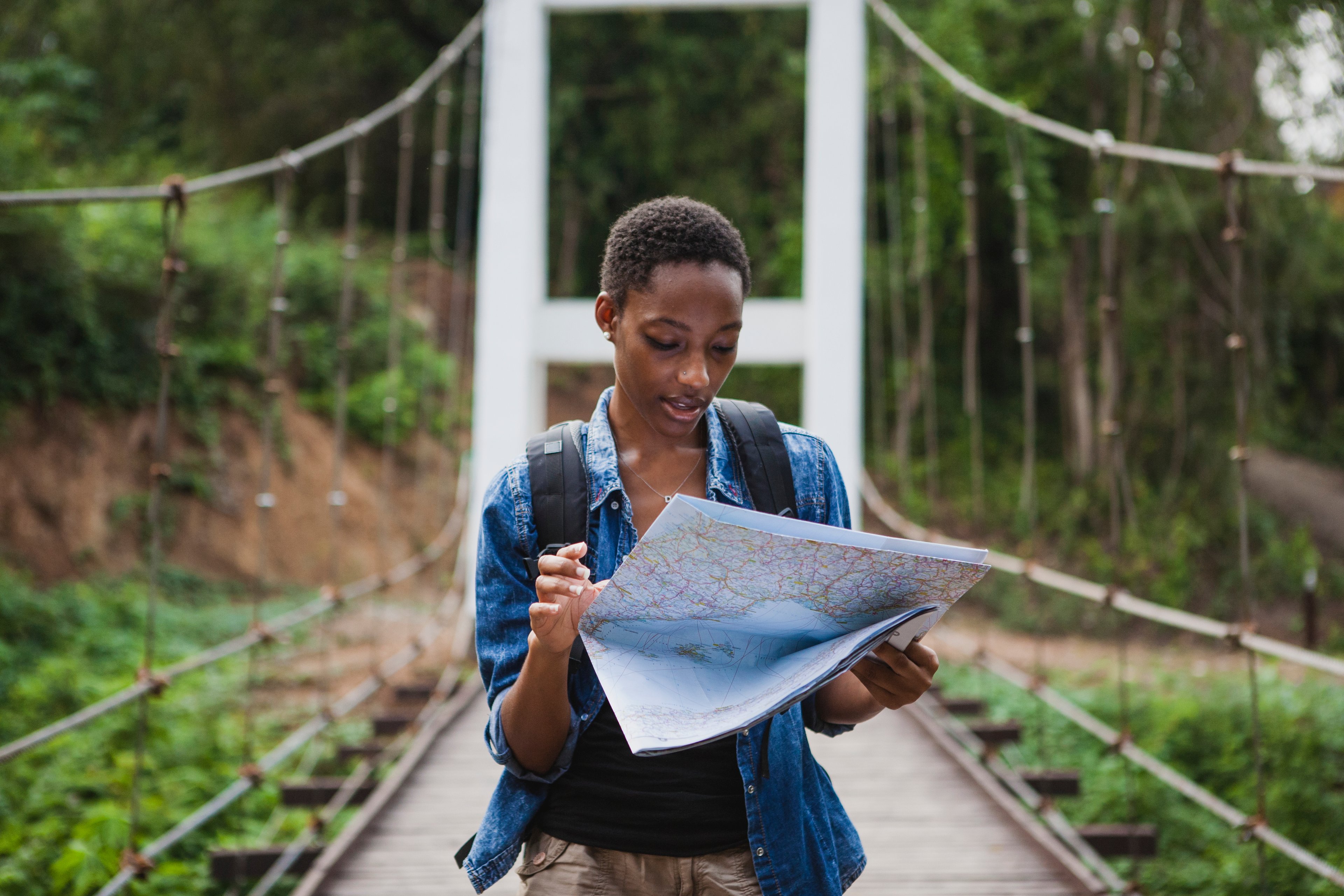 Person using a map to navigate their adventure.