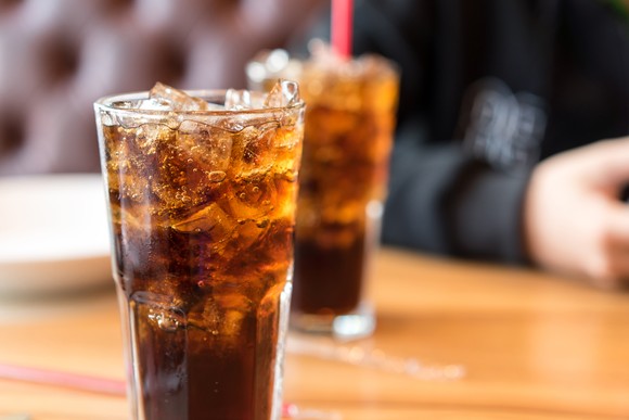 Two glasses of iced cola