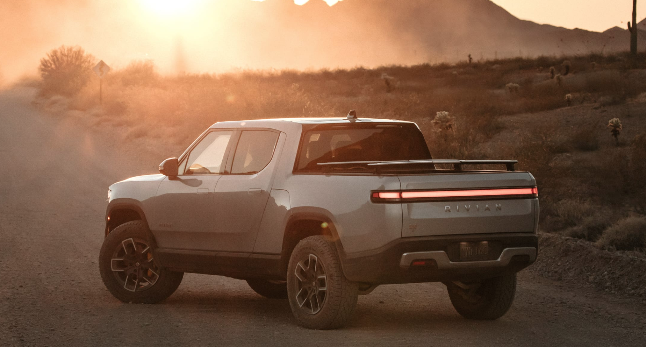 Rivian R1T truck at sunset.