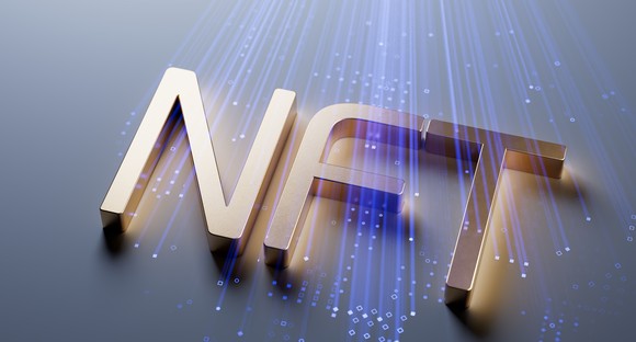 NFT gold letters on blue digital background.