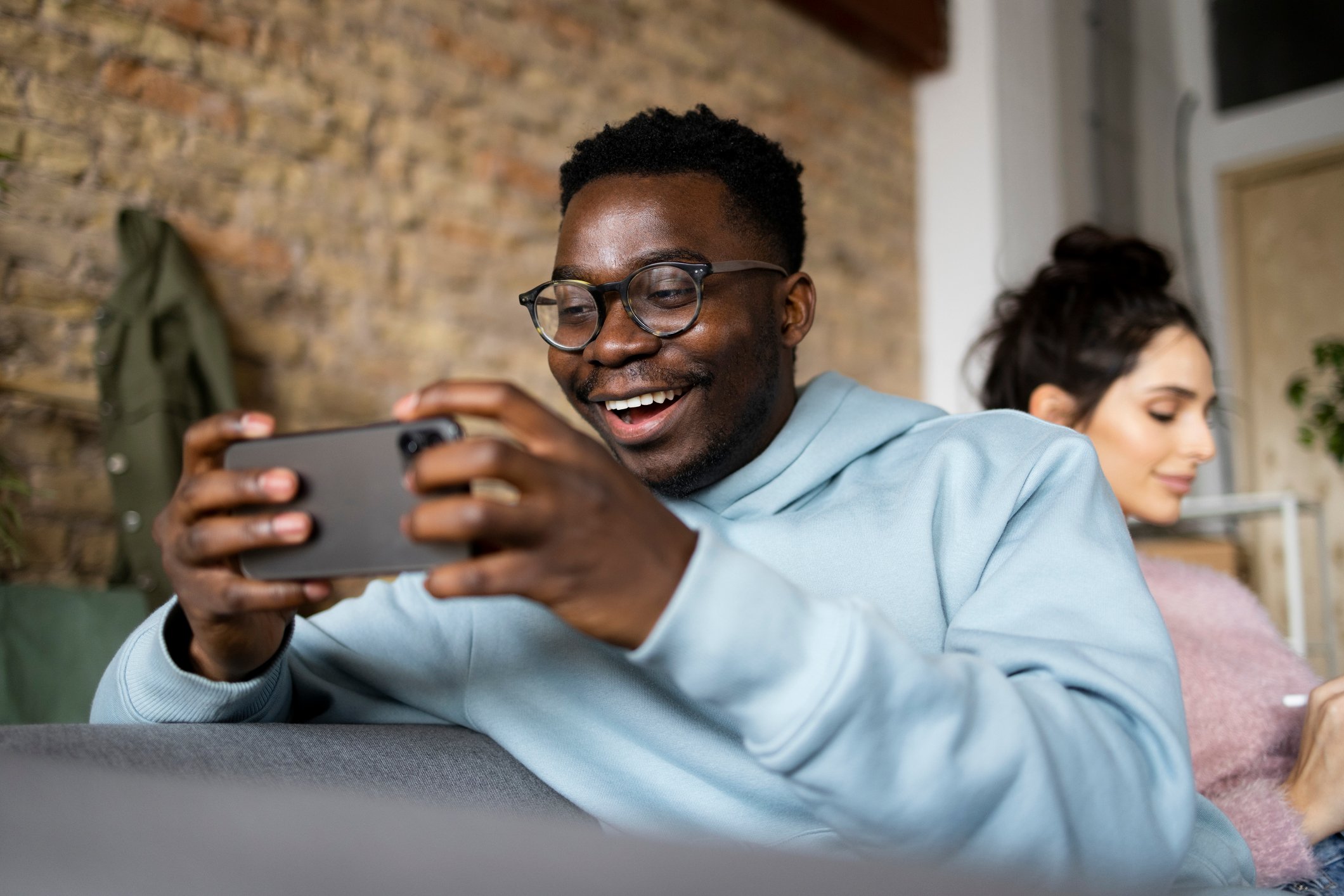 A person plays a video game on a smartphone.