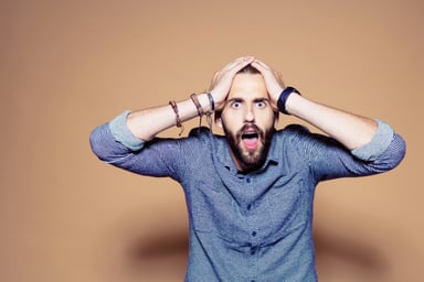 shocked overwhelmed hands on head