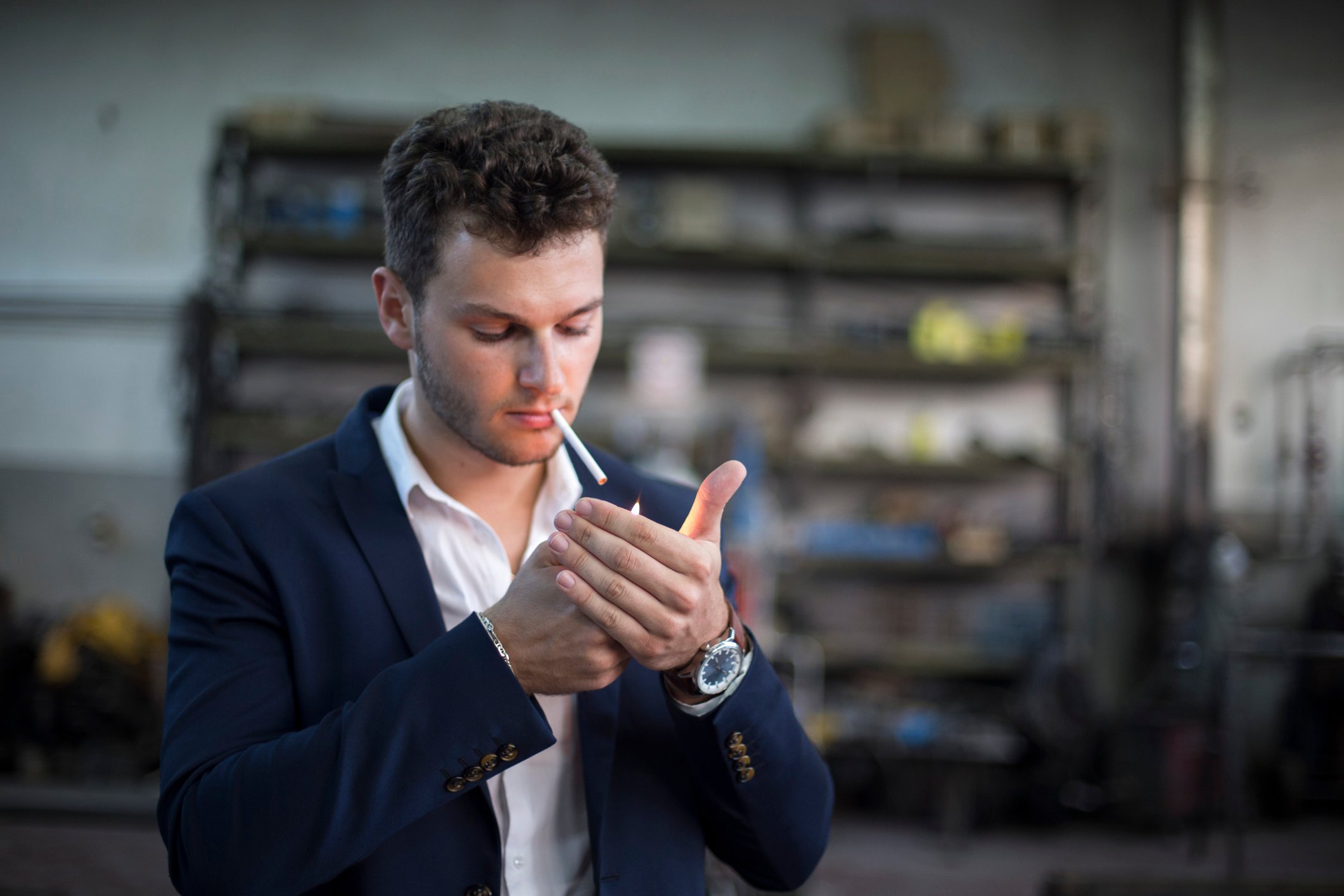 A person lights up a cigarette.
