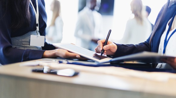 Person signing digital signature on a tablet