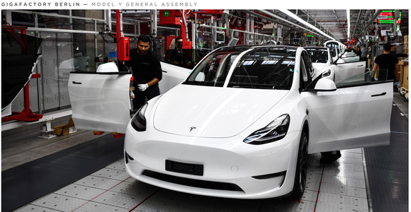 White Tesla Model Y on production line.