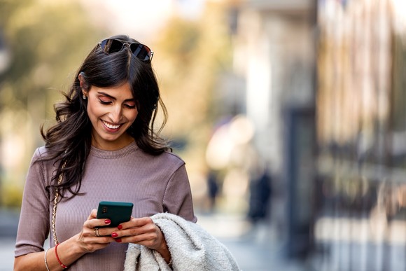 A woman looking at her smartphone.