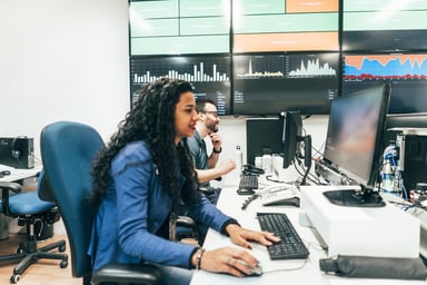 Office workers and screens with charts