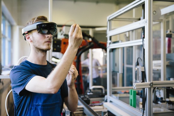 Engineer using artificial intelligence and virtual reality tools to assist in design.