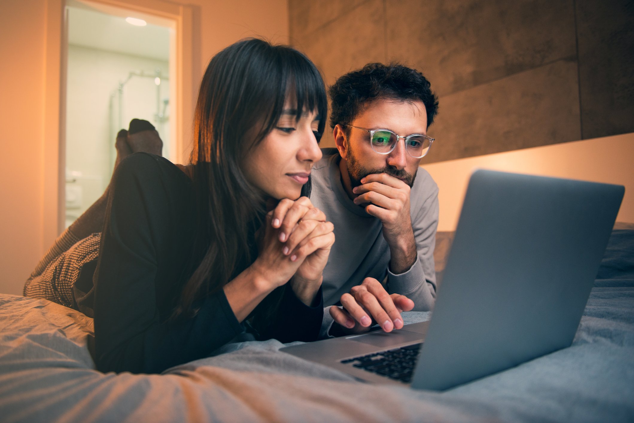 2 people looking at laptop.