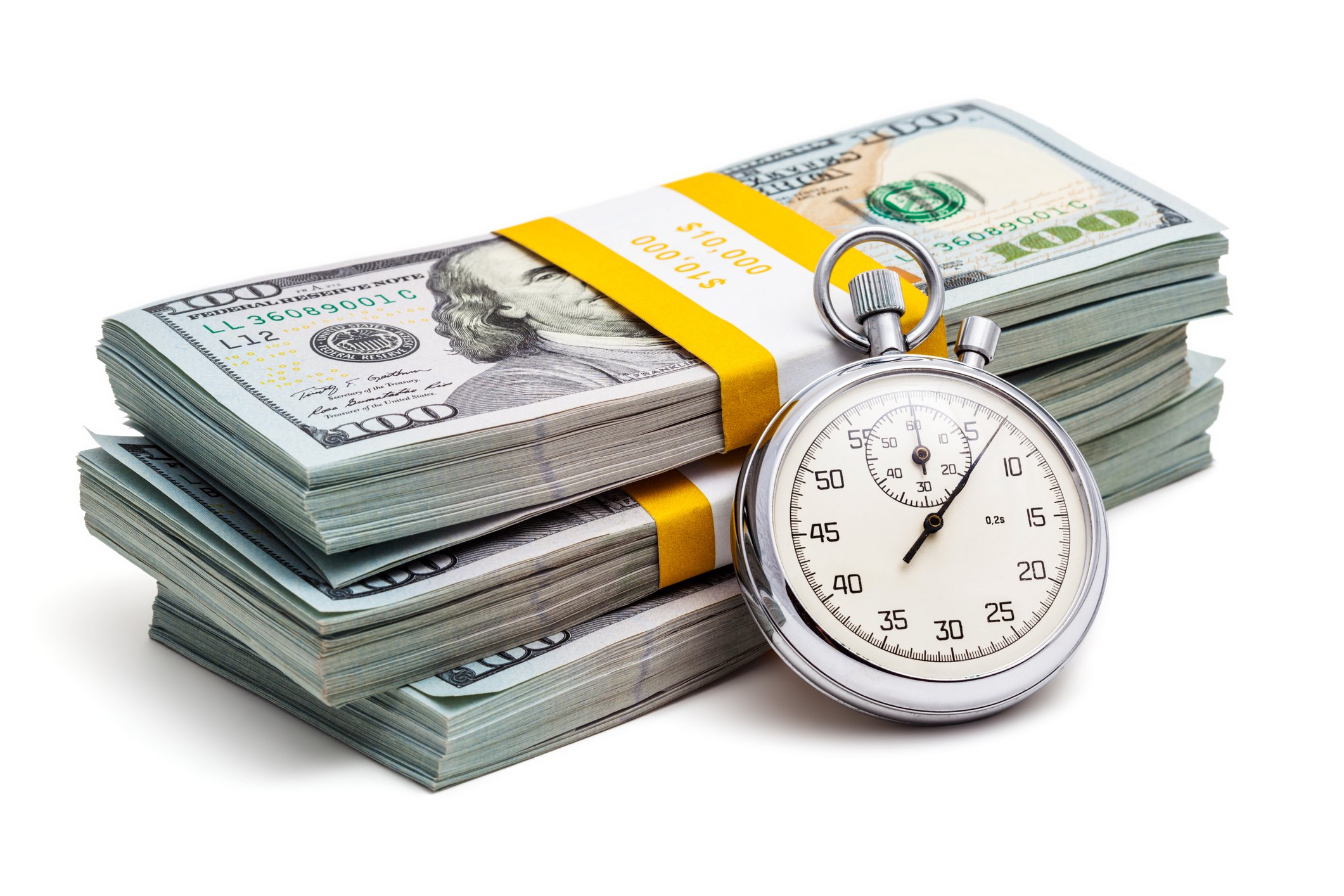Stopwatch leaning on stacks of $100 bills.