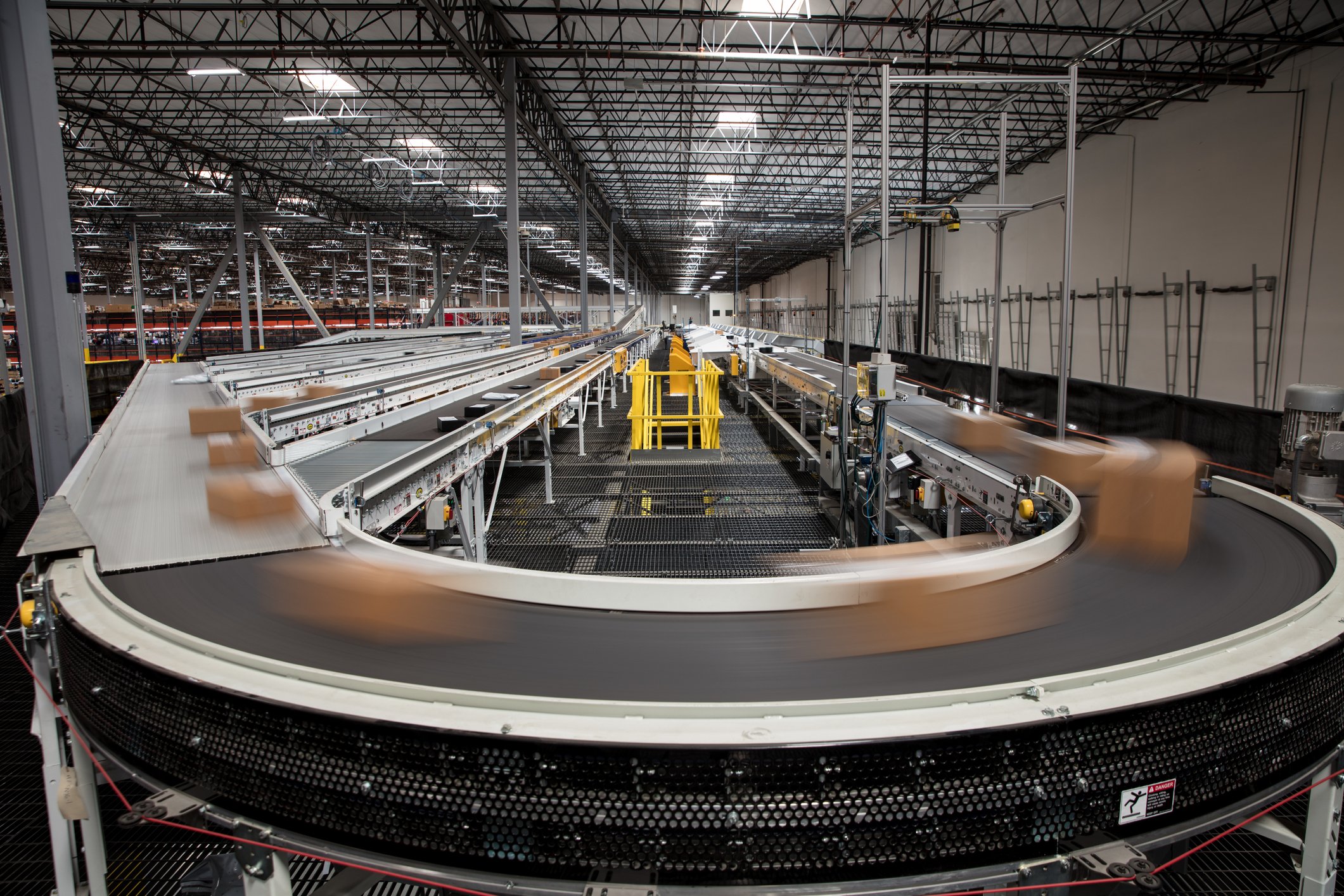 Packages moving around a conveyor belt.